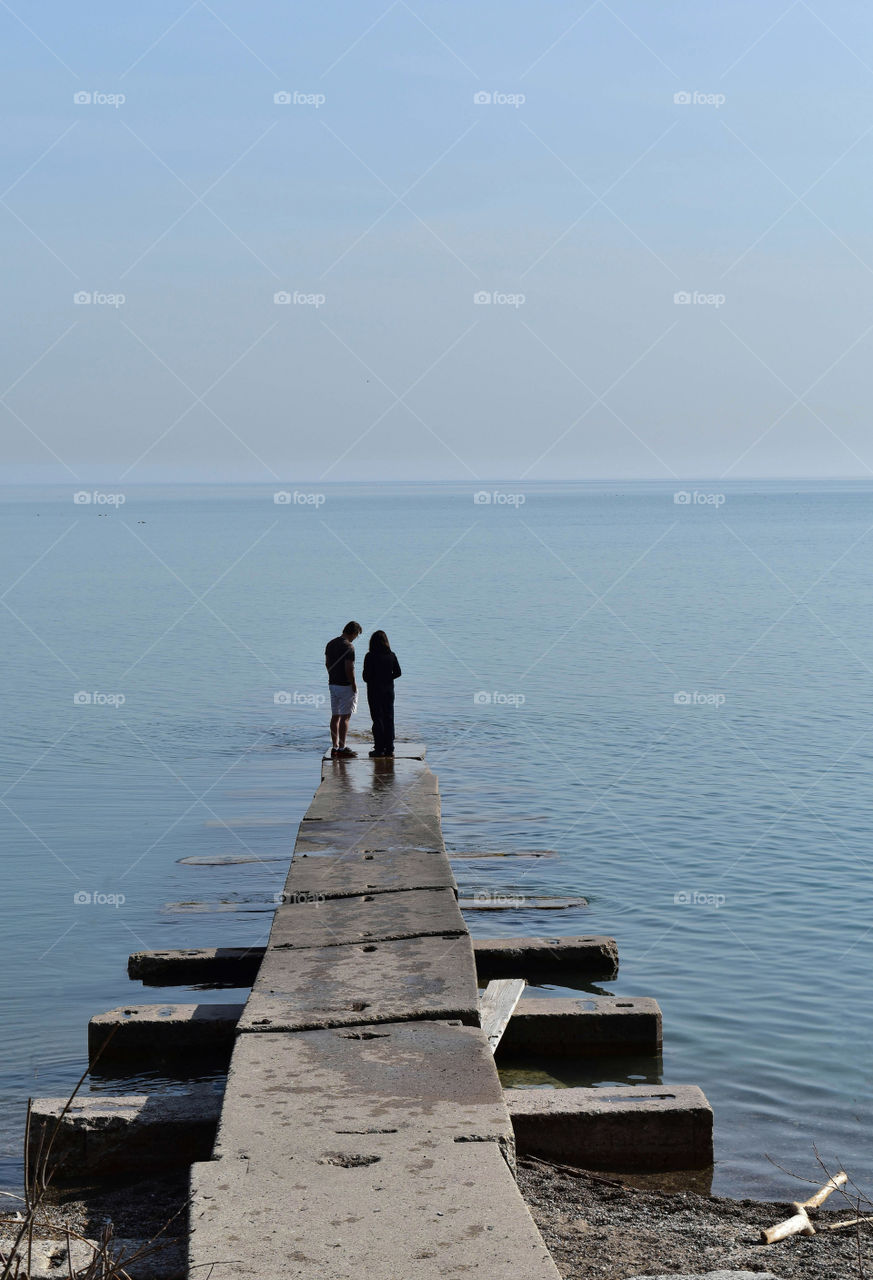 Romantic couple on a break water at Lake Michigan