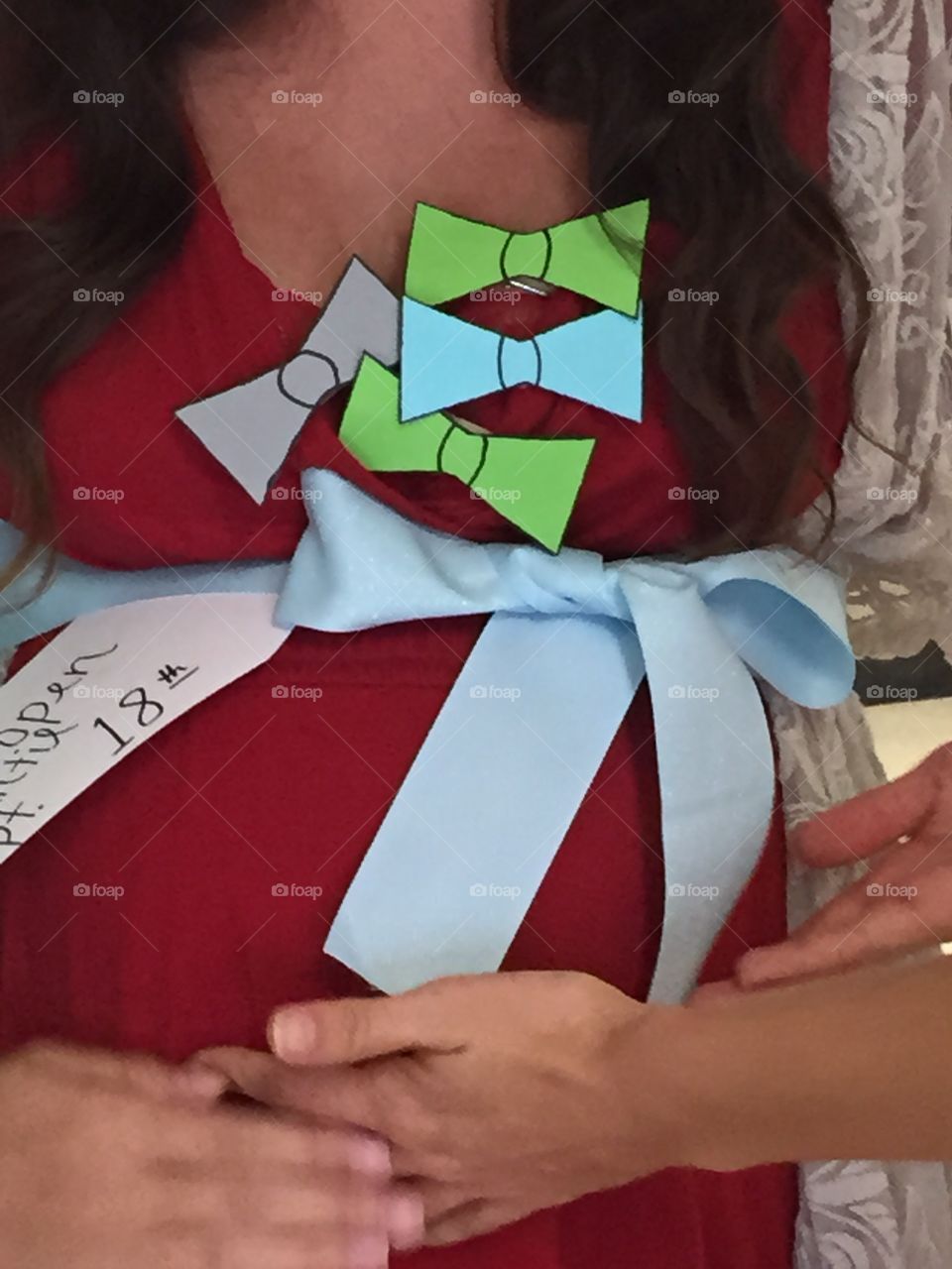Pregnant young woman's tummy decorated for the shower that was given for her.