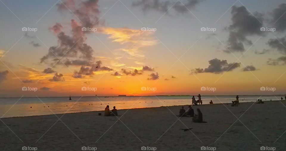 sunset reflection over ocean in a sandy beach