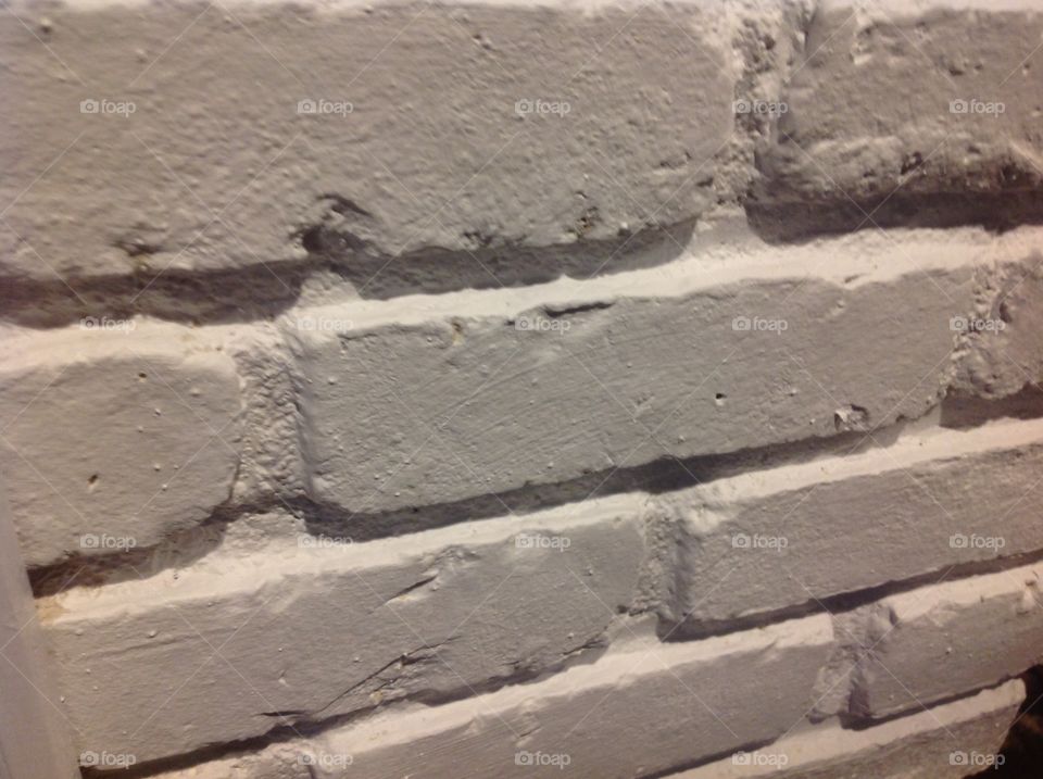 An up close photo of a white brick wall.