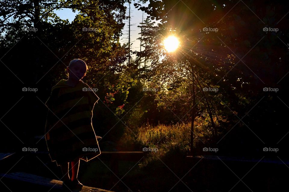 Small girl standing in forest