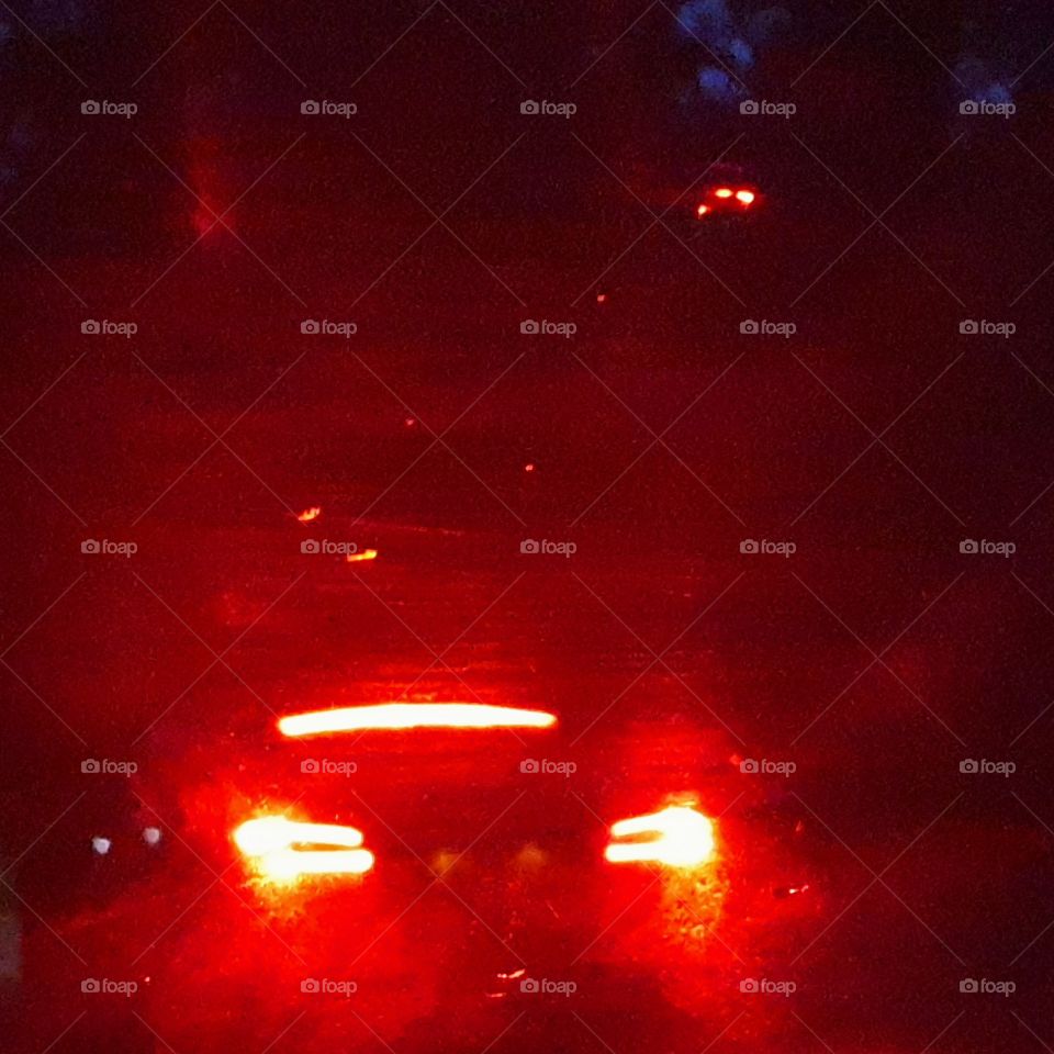 Car with illuminated rear lights.