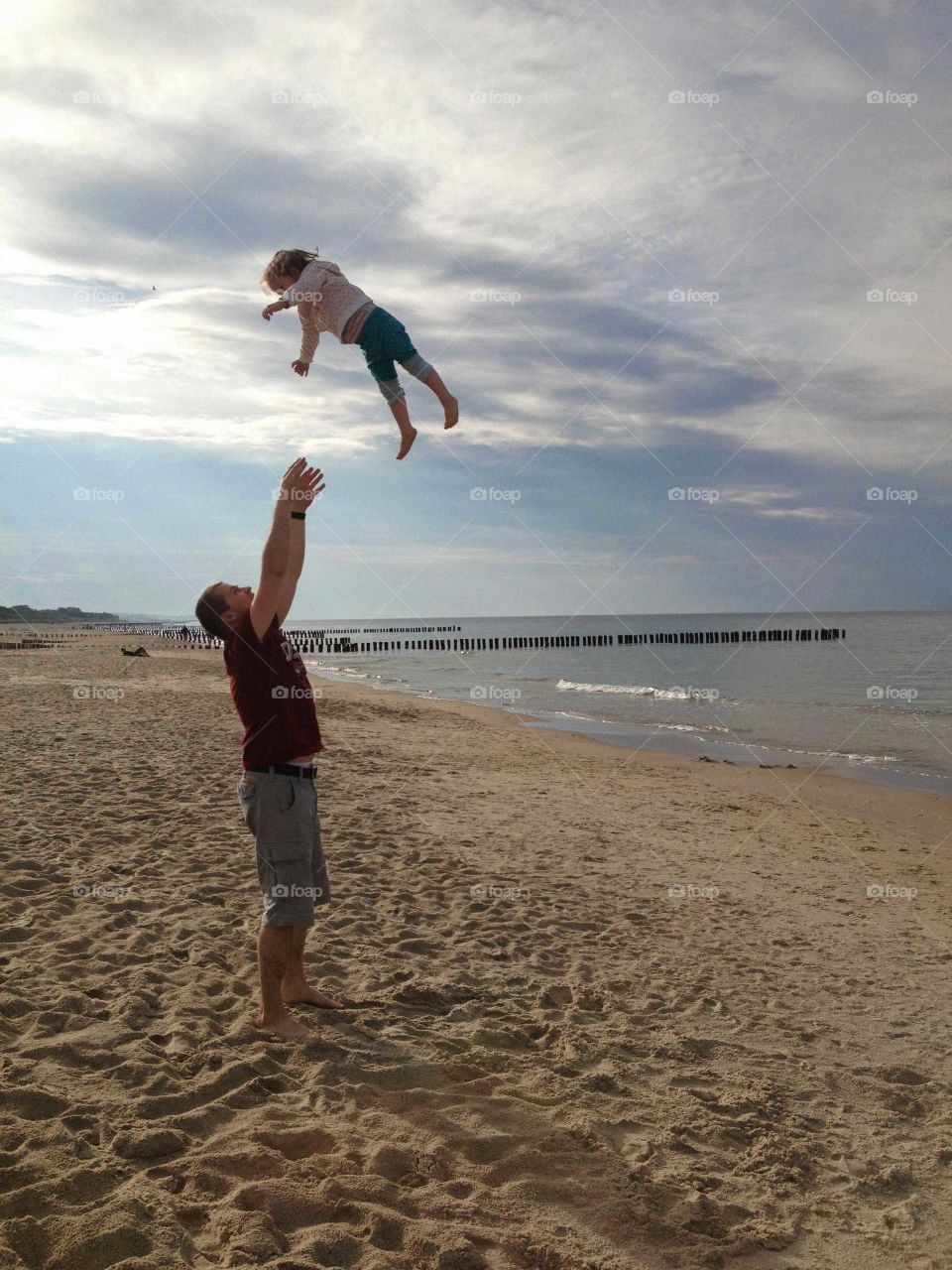 Father and daughter playing at the beach