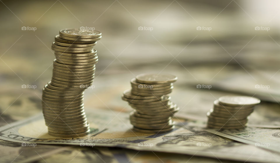 coin stacks on a dollar banknotes. investment ideas and financial managment concept