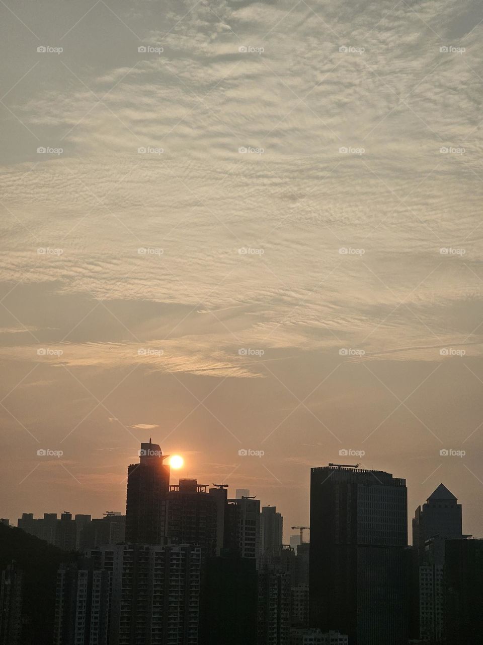 sunset buildings silhouette with thin clouds