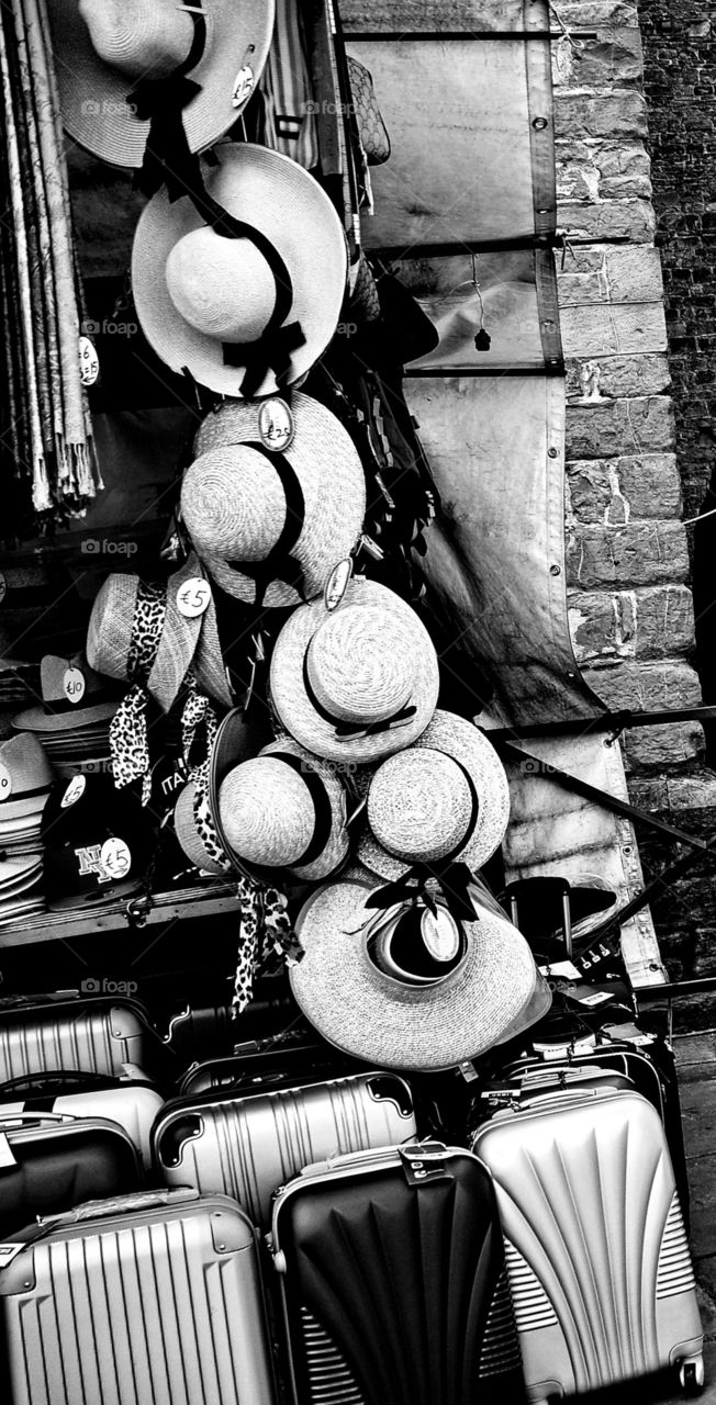 Hat and suitcases in market