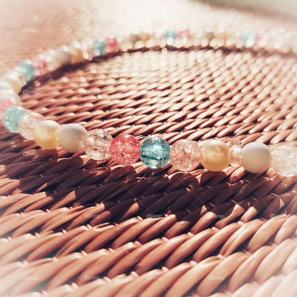 reflection of sunrays on beads and shadow