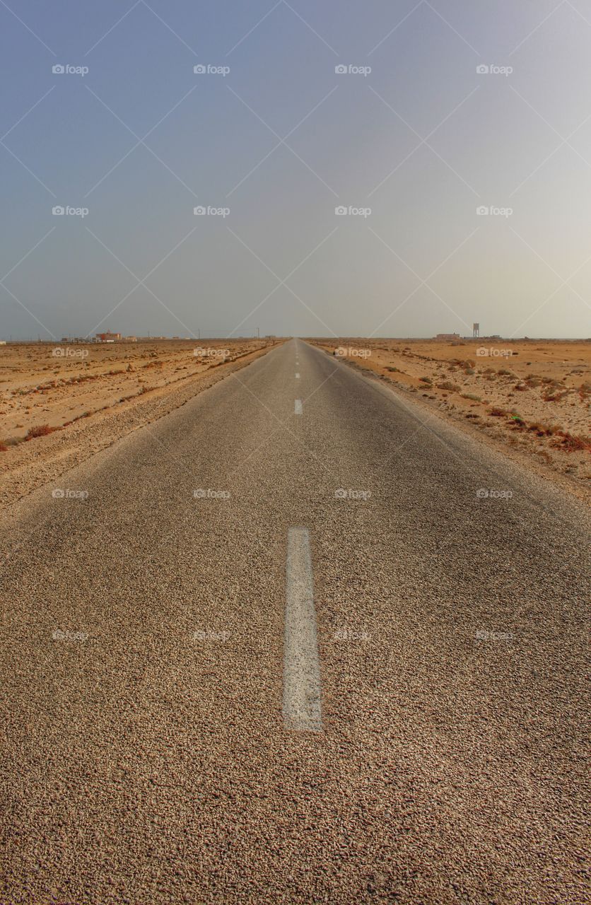 Scenic view of empty road through desert