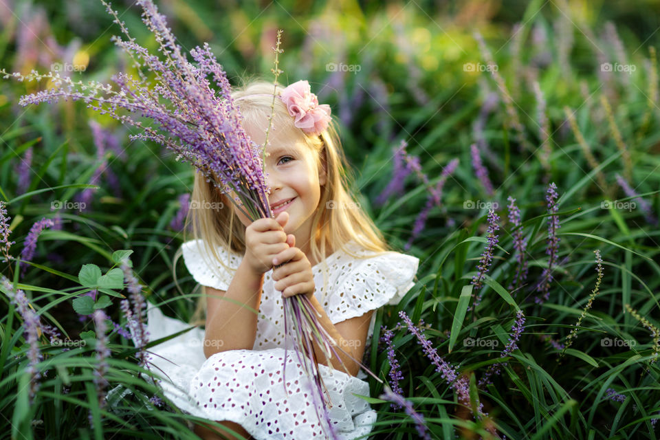 Cute little girl with blonde hair outdoor 