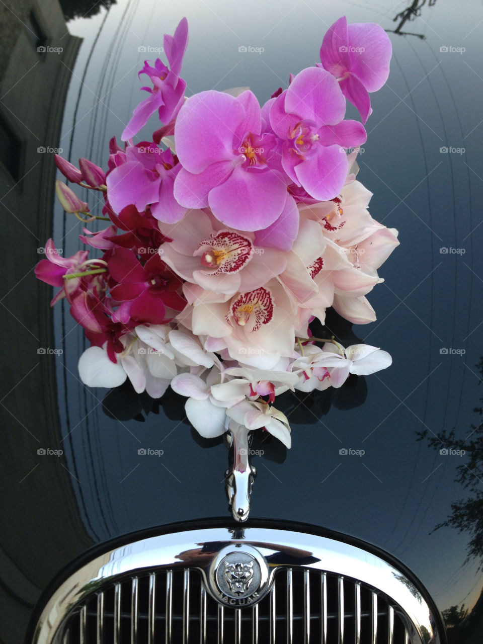 Wedding flower bouquet sitting on a Jaguar car