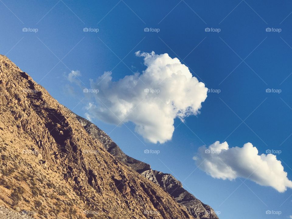 Clouds teasing the mountainous desert landscape of Nevada