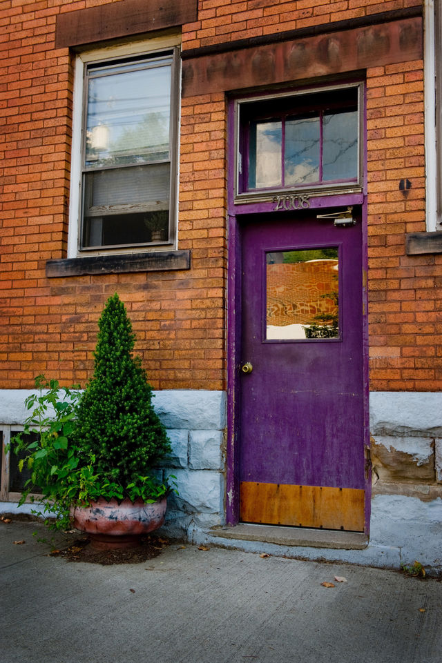 Image of a purple door in a brick building