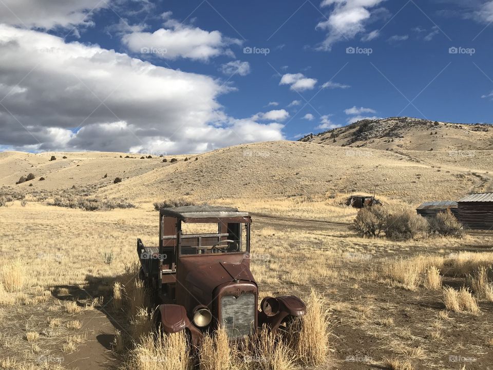 Old abandoned car in the middle of nowhere Montana 