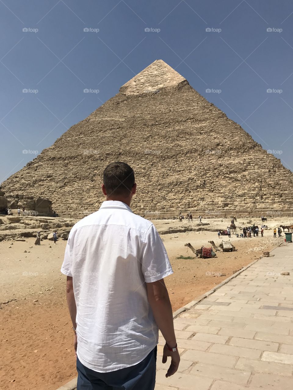 A boy walking to the pyramid.