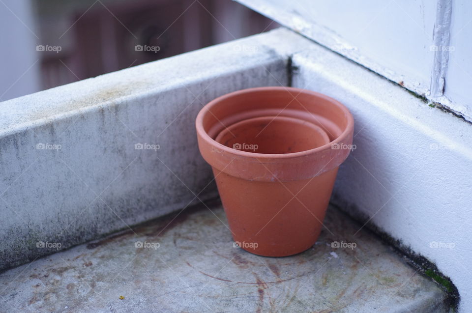 Simply red ceramic bucket at the corner