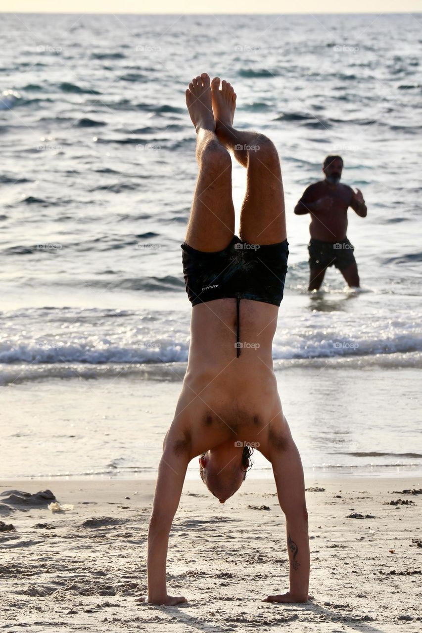 Handstand. Stunts on the beach