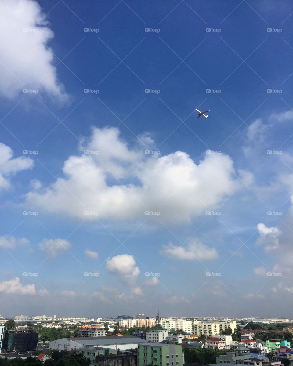 A plane flies over the city