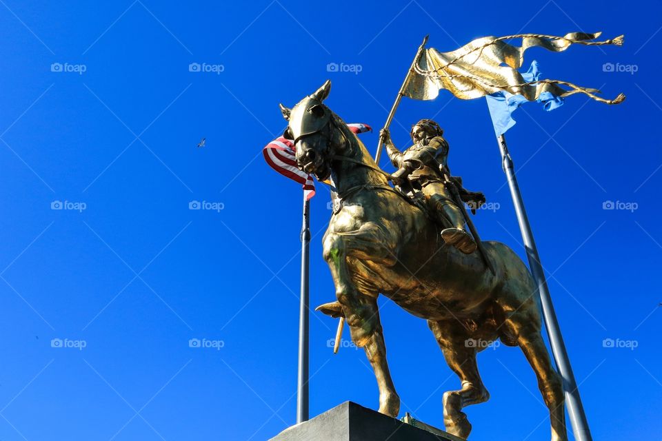 Joan of arc statue with clear blue sky