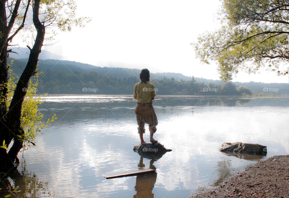 A woman on the rock in the lake