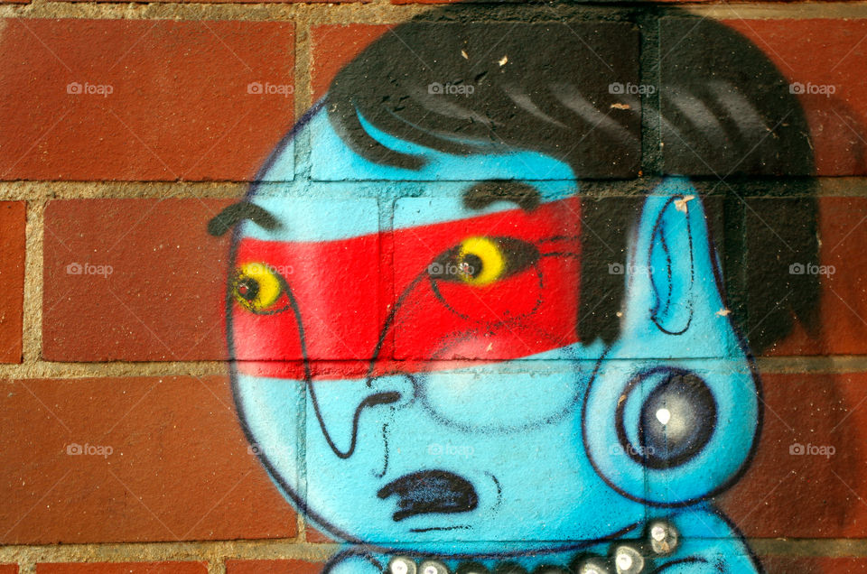 Close-up of multi colored painted work on brick wall in Berlin, Germany.