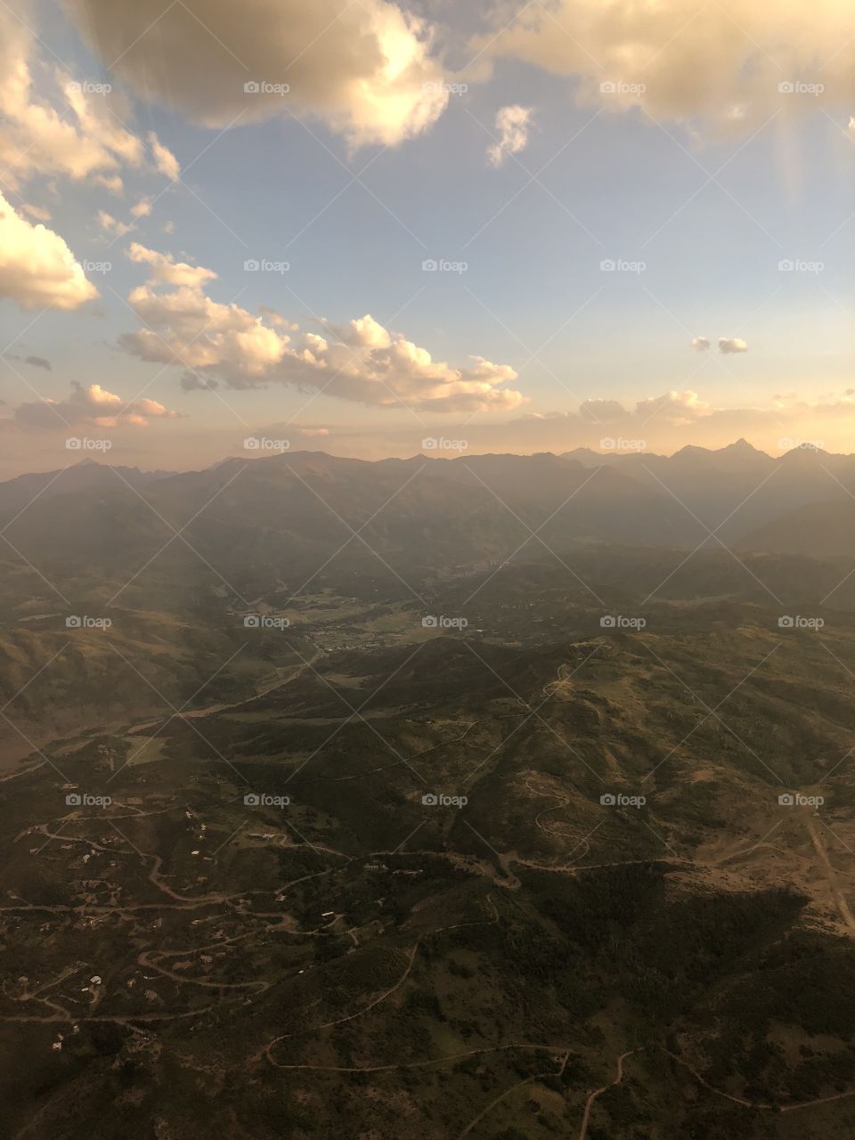 Sunset view of mountains from airplane 