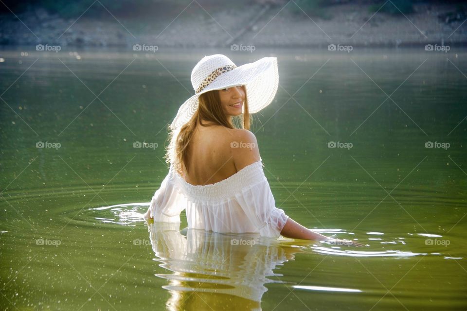 Beautiful happy woman in water