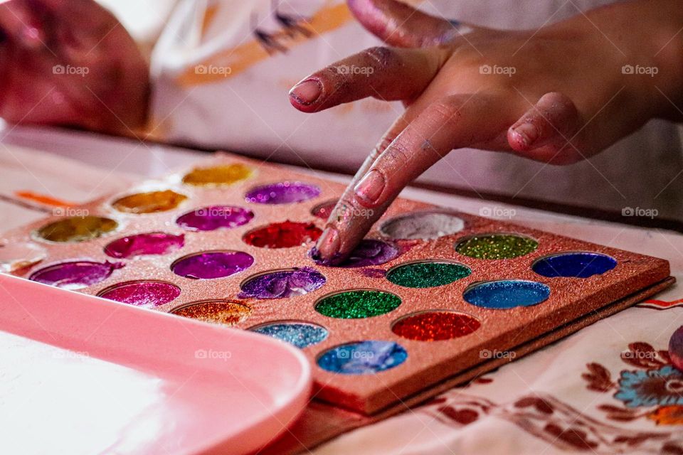 Child trying glitter make up