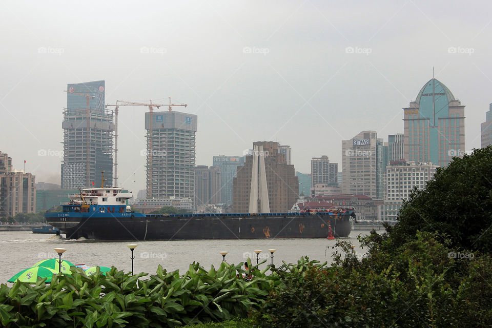 Freighter on huangpu river. A huge freigther sailing through huangpu river, shanghai, china.