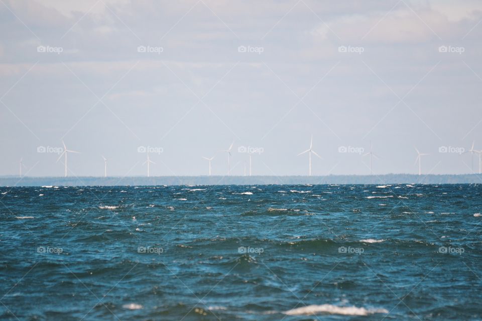 Beautiful ocean with windmills in the background