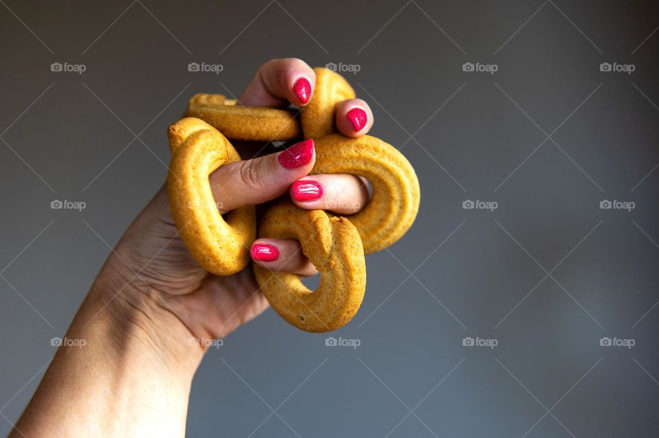 Hand holding butter cookies rings