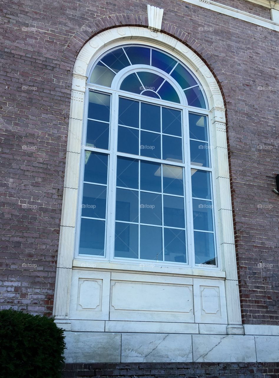 Window in US Post Office building after it was restored, leaving original glass. Marble & brickwork all original. From 1920s. Town in New England.