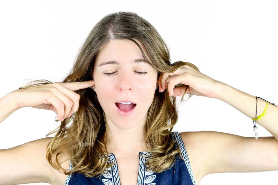 Woman covering her ears