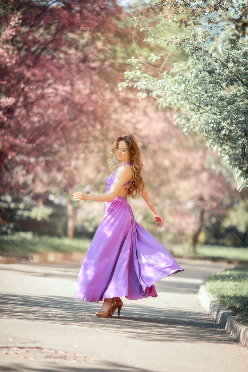 Beautiful young woman in a blossom park 