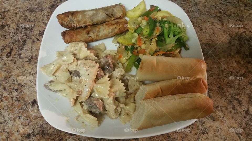creamy bowtie pasta ,breadsticks, sauteed vegetables and egg rolls