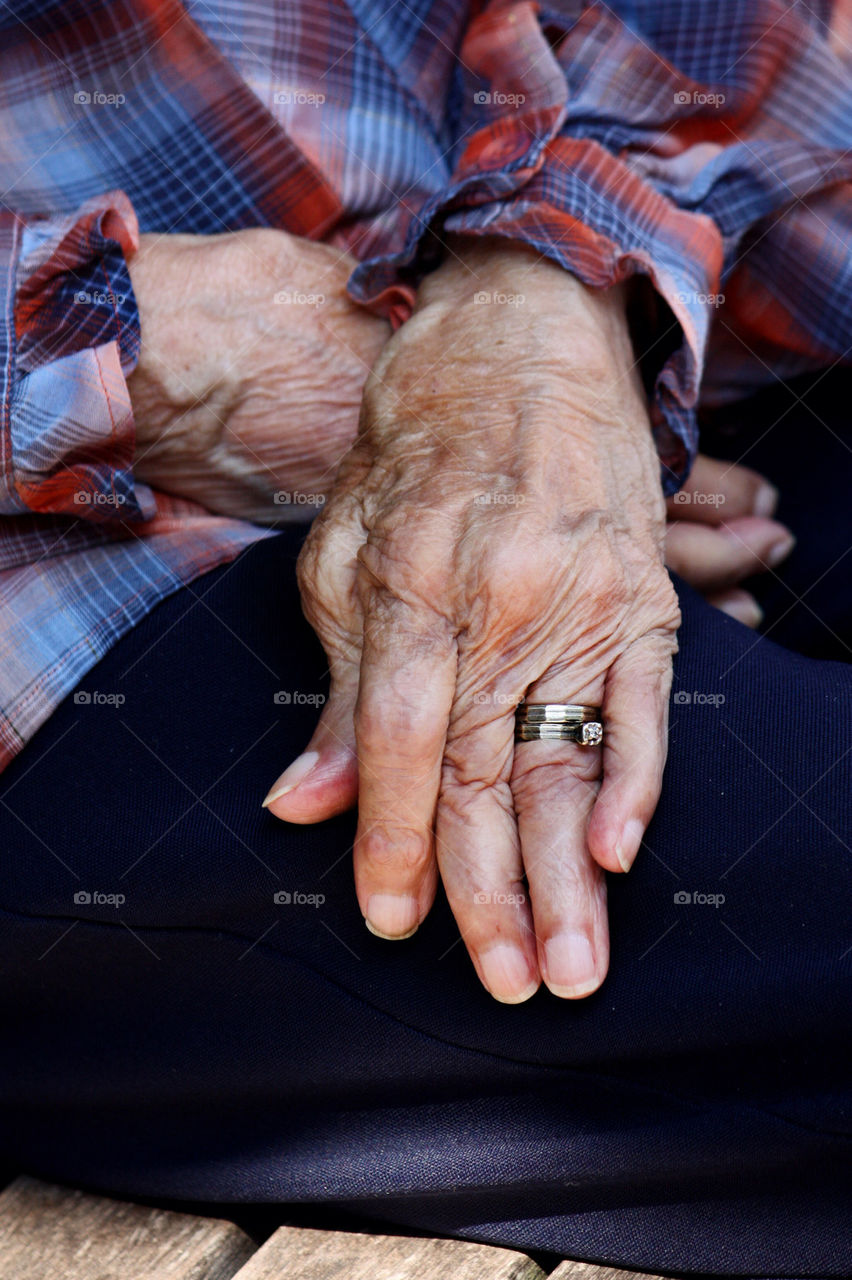 Aged hands with wedding rings
