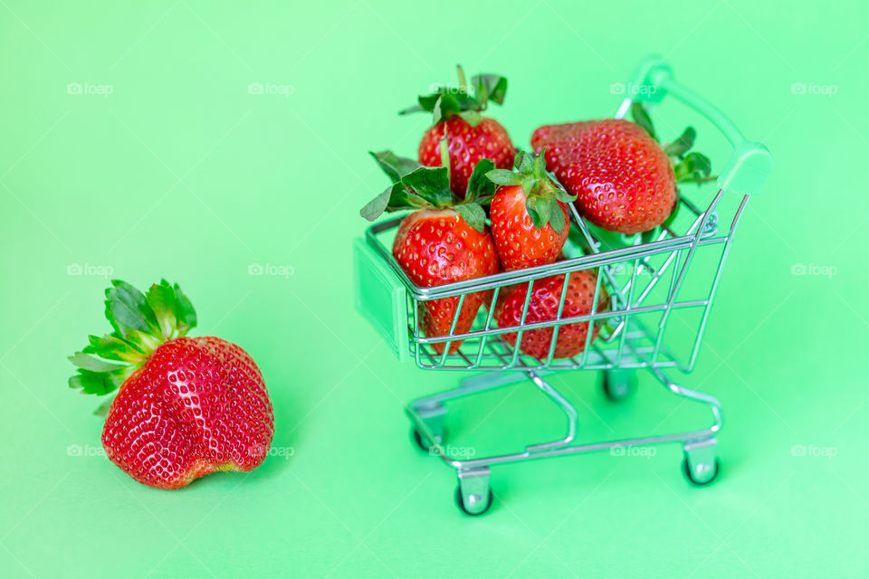 Juicy fresh red strawberries in a shopping cart