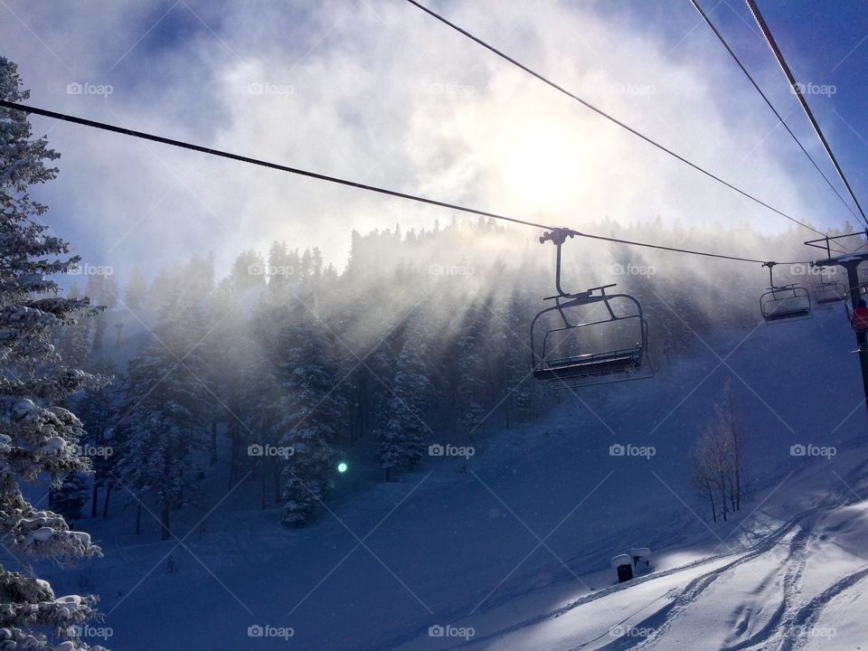 Ski lift, snow and sun beams