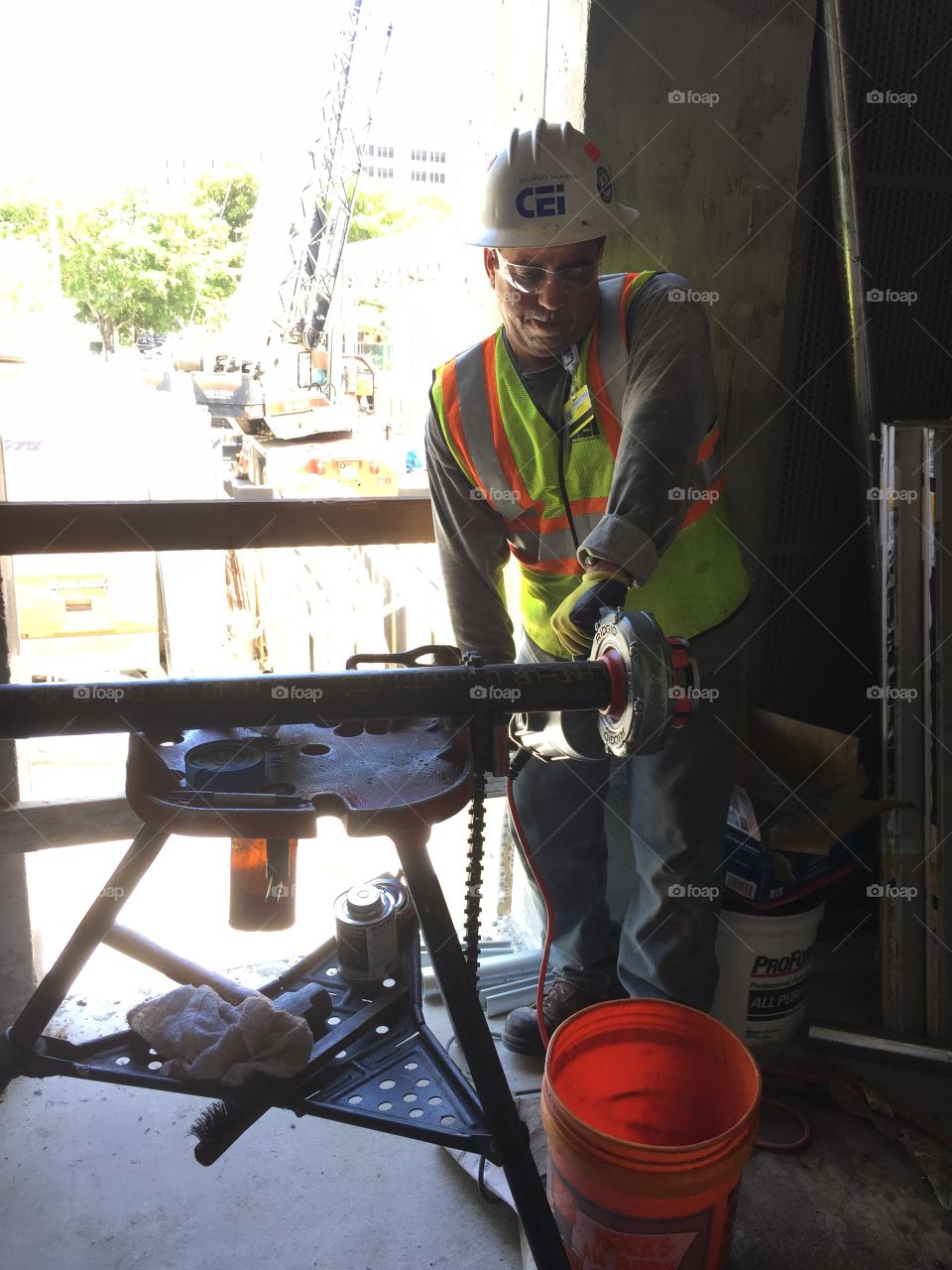 Worker . Man cutting pipe at construction site