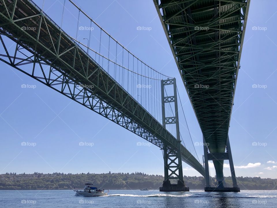 Boat passing under the Tacoma Narrows Bridge