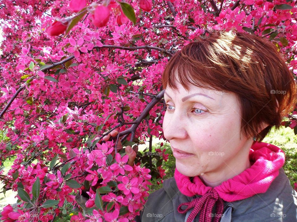 girl on the background of a flowering tree in spring