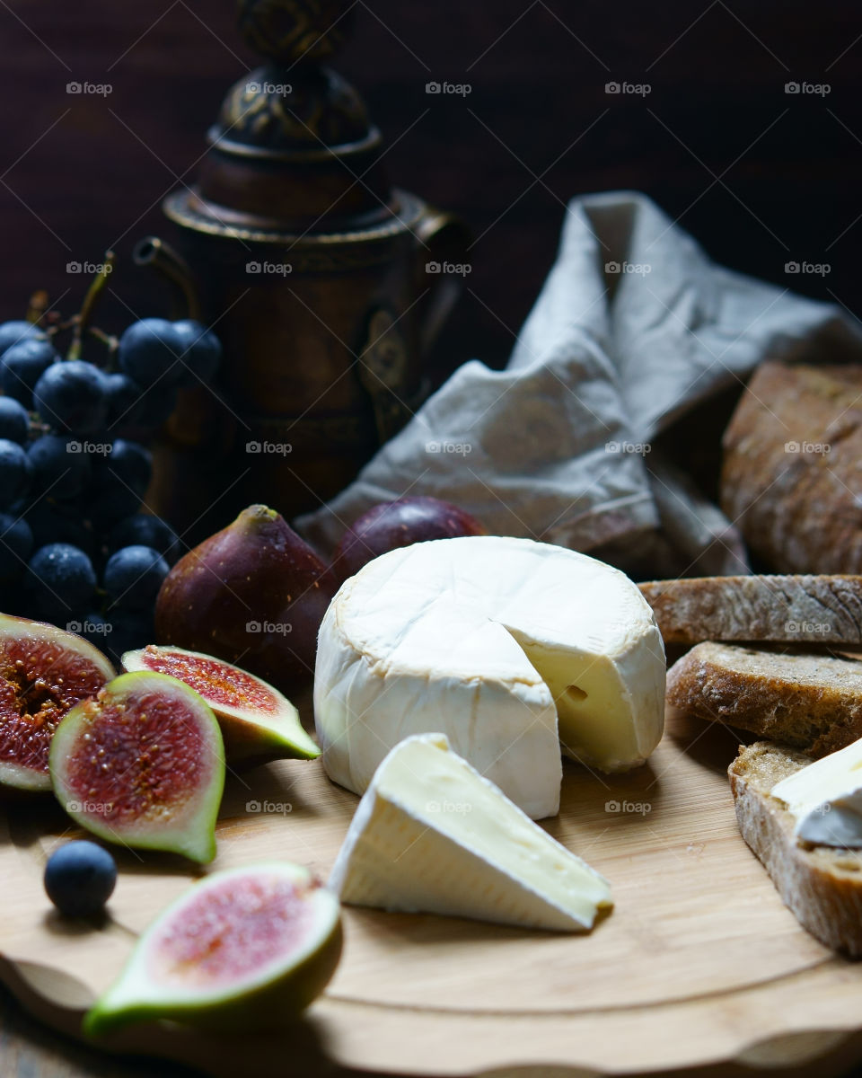 High angle view of cheese and fruit on table