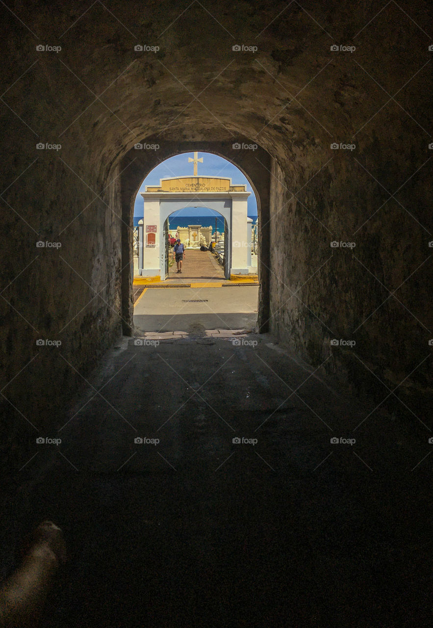 One of a kind - walking through a tunnel contrasting the dark with the light at the end, although a cemetery awaits on the other side.  