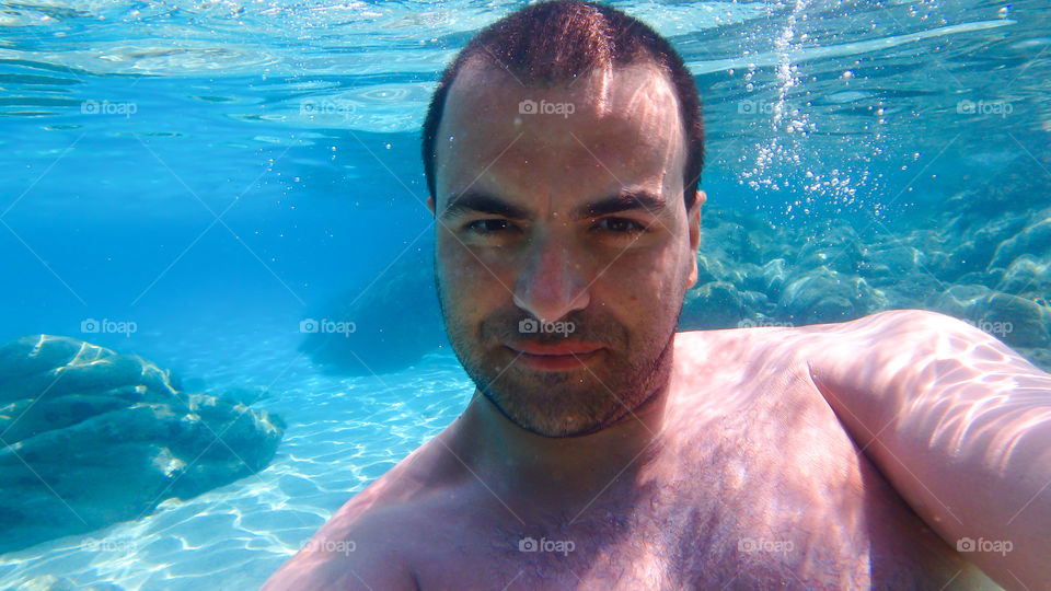 young man underwater portrait