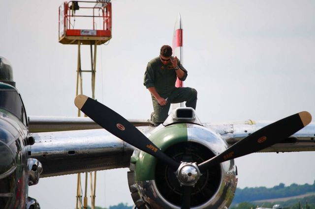 Pilot on the wing of a WWII bomber at airport