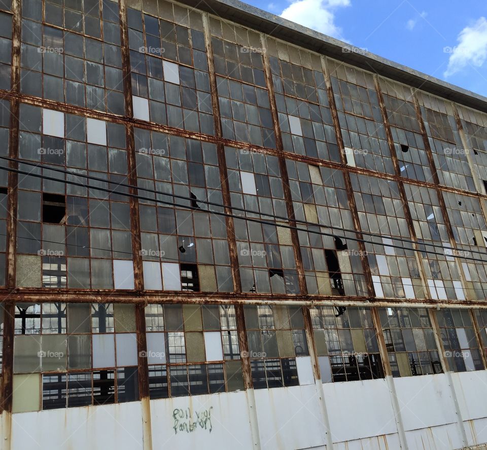 Old building with all glass windows some broken in small city in Georgia.