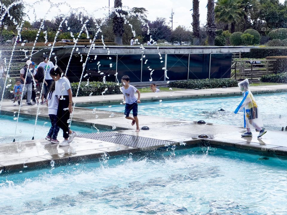 Children playing in a fountain 