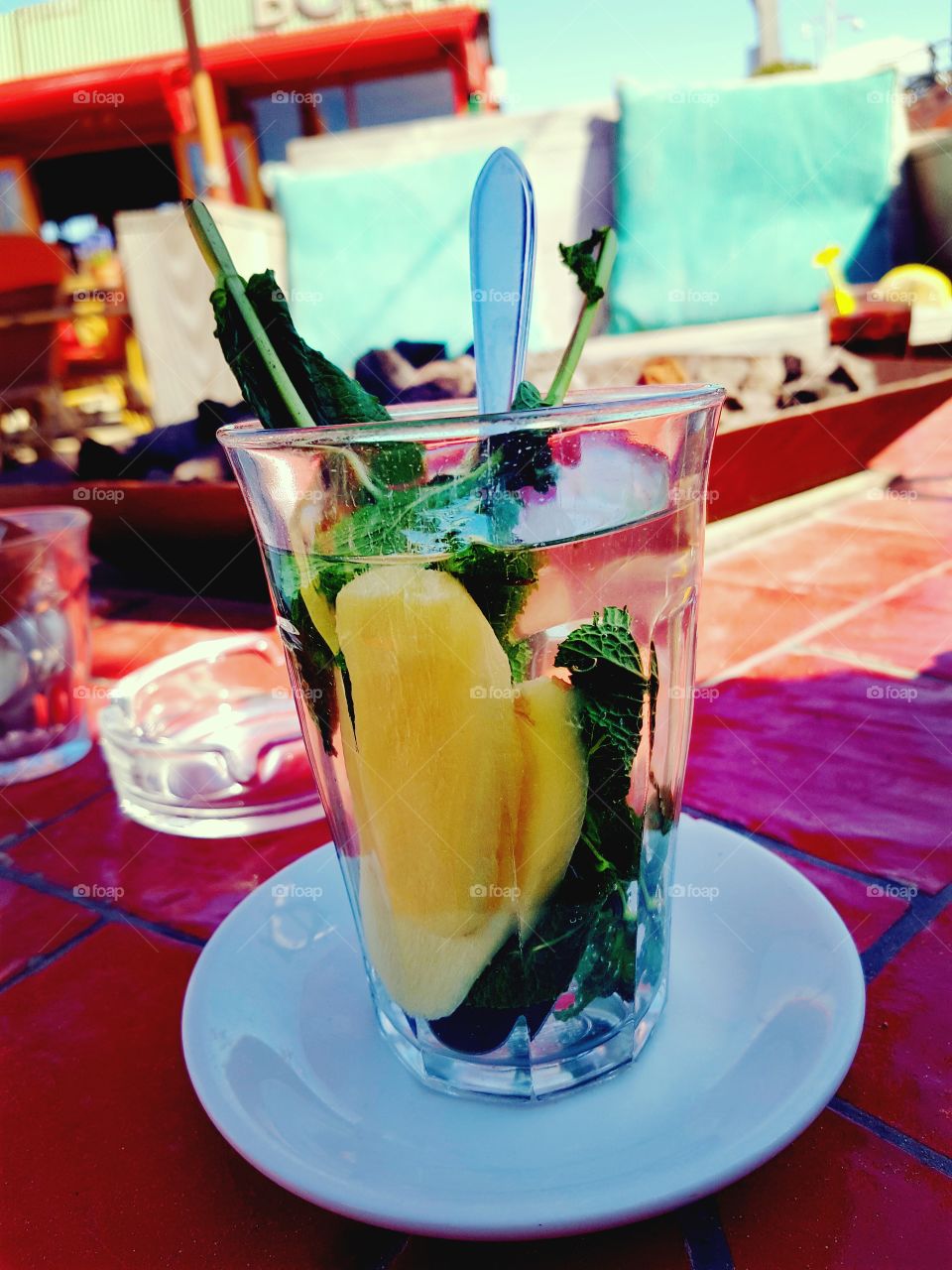 Fresh mint tea with ginger on a sunny terrace.
