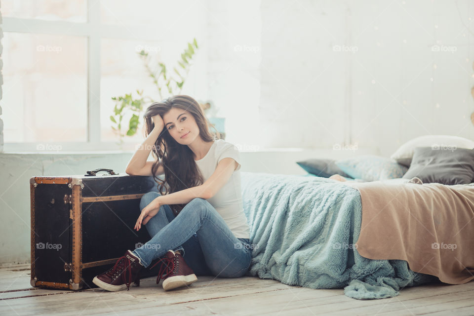 Beautiful young woman at home in daylight 