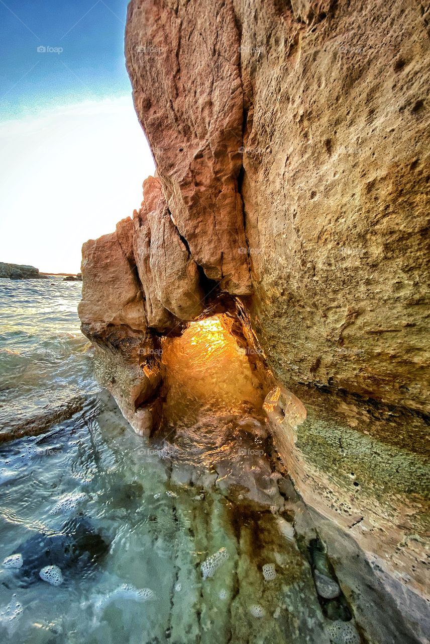 Golden water through a cave! An amazing sunset in Paphos , Cyprus 