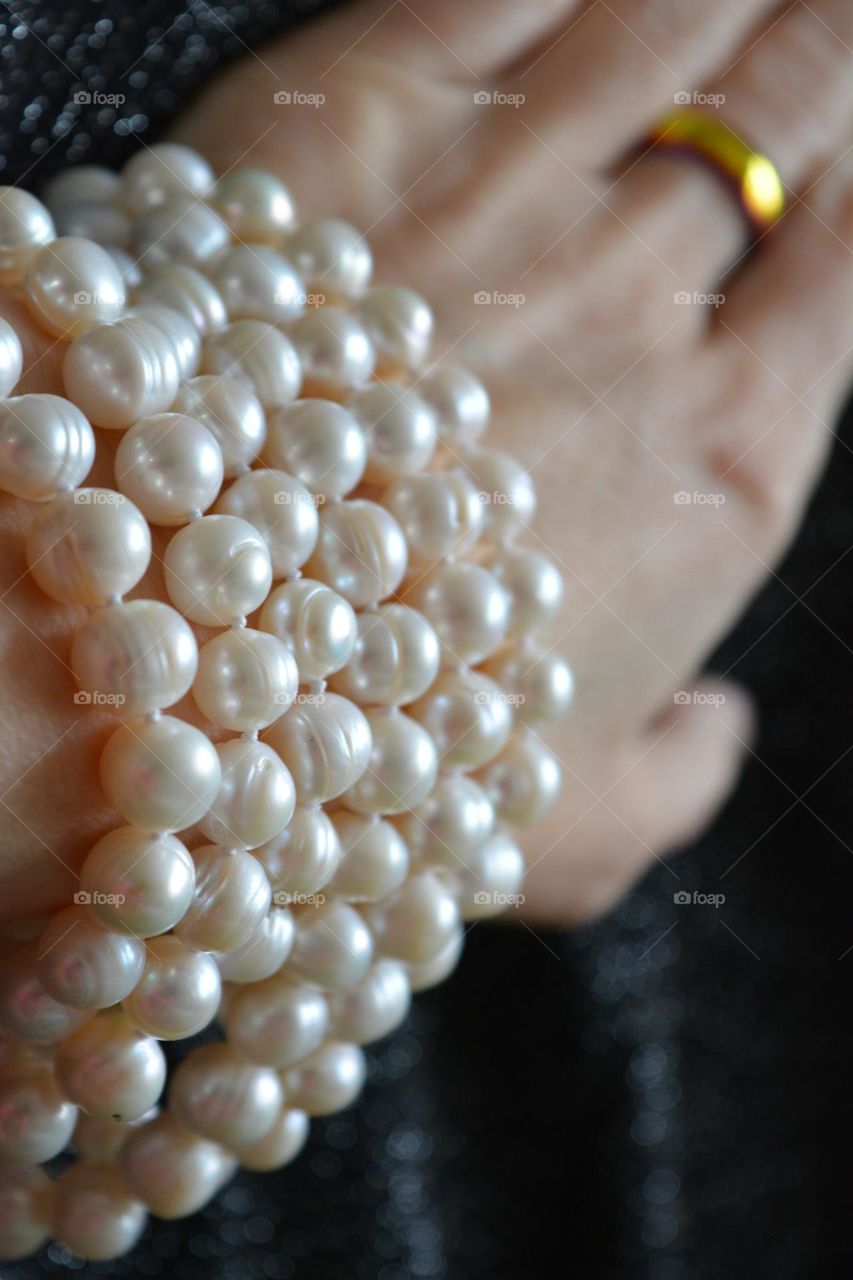 female hand with bracelet pearls beautiful accessories close up